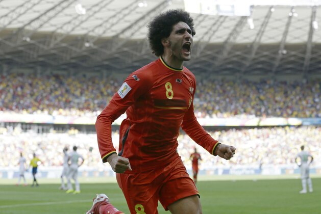 Belgium's Marouane Fellaini celebrates after scoring his side's first goal during the group H World Cup soccer match between Belgium and Algeria at the Mineirao Stadium in Belo Horizonte, Brazil, Tuesday, June 17, 2014.  (AP Photo/Hassan Ammar)