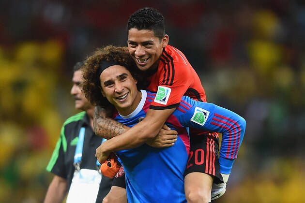 FORTALEZA, BRAZIL - JUNE 17:  Goalkeeper Guillermo Ochoa of Mexico celebrates with Javier Aquino after their 0-0 draw with Brazil during the 2014 FIFA World Cup Brazil Group A match between Brazil and Mexico at Castelao on June 17, 2014 in Fortaleza, Brazil.  (Photo by Laurence Griffiths/Getty Images)