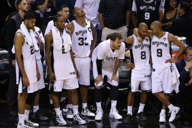 SAN ANTONIO, TX - JUNE 15:  Tim Duncan #21, Kawhi Leonard #2, Danny Green #4, Boris Diaw #33, Tiago Splitter #22, Patty Mills #8 and Tony Parker #9 watch as their team defeat the Miami Heat in Game Five of the 2014 NBA Finals at the AT&T Center on June 15, 2014 in San Antonio, Texas. NOTE TO USER: User expressly acknowledges and agrees that, by downloading and/or using this photograph, user is consenting to the terms and conditions of the Getty Images License Agreement. (Photo by Chris Covatta/Getty Images)