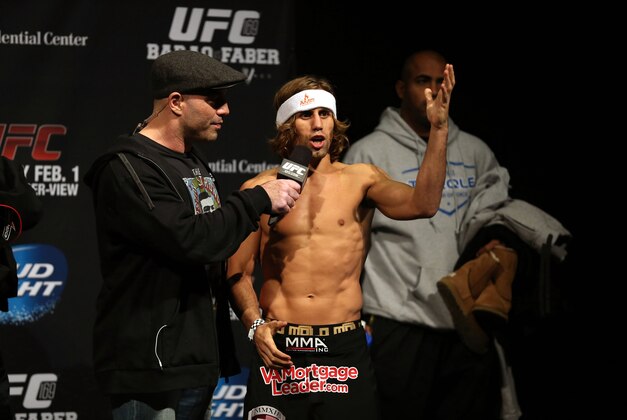 Jan 31, 2014; Newark, NJ, USA; Urijah Faber (right) is interviewed by UFC commentator Joe Rogan after weighing in for his Bantamweight Championship bout against Renan Barao (not pictured) at Prudential Center. Mandatory Credit: Joe Camporeale-USA TODAY Sports