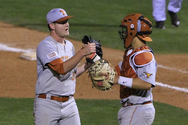 Texas pitcher Chad Hollingsworth, left, and catcher Tres Barrera, right, celebrate after defeating Texas Tech in the first-round game against of the Big 12 conference NCAA college baseball tournament in Oklahoma City, Wednesday, May 21, 2014. Texas won 8-3. (AP Photo/Alonzo Adams)