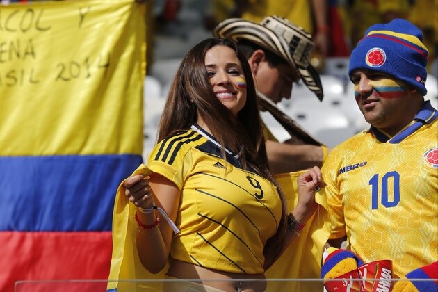 A Colombian supporter smiles as she waits for the start of the group C World Cup soccer match between Colombia and Greece at the Mineirao Stadium in Belo Horizonte, Brazil, Saturday, June 14, 2014.   (AP Photo/Jon Super)