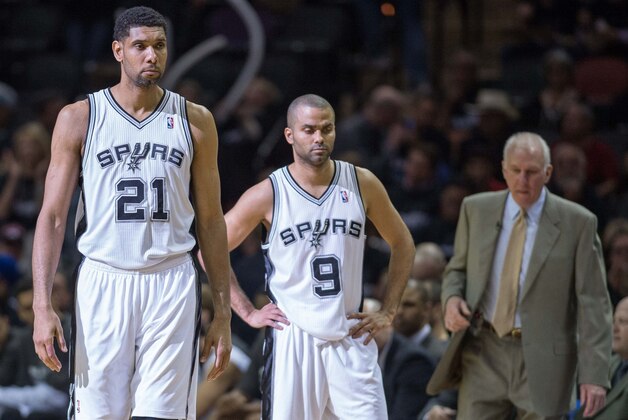 Apr 20, 2014; San Antonio, TX, USA; San Antonio Spurs forward Tim Duncan (21) and guard Tony Parker (9) and head coach Gregg Popovich during the game against the Dallas Mavericks in the first round of the 2014 NBA Playoffs at AT&T Center. The Spurs defeated the Mavericks 90-85. Mandatory Credit: Jerome Miron-USA TODAY Sports