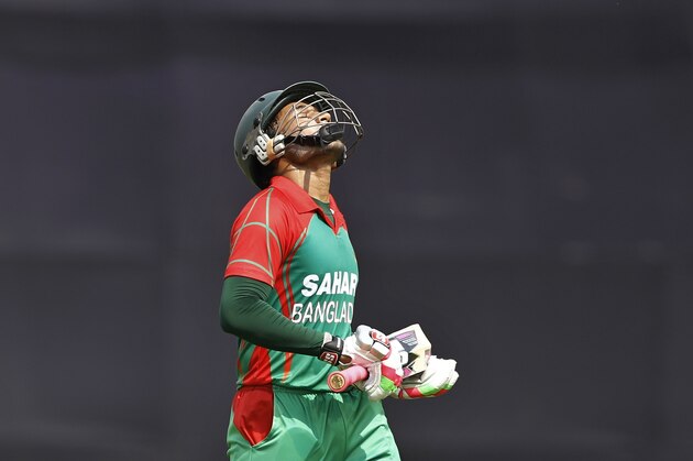 Bangladesh captain Mushfiqur Rahim reacts as he walks back to the pavilion after his dismissal by India's Parvez Rasool  during their first one-day International cricket match in Dhaka, Bangladesh, Sunday, June 15, 2014. (AP Photo/A.M. Ahad)