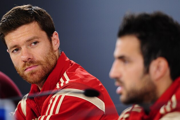Spain's Xabi Alonso, left, and Cesc Fabregas attend a press conference at the Atletico Paranaense training center in Curitiba, Brazil, Sunday, June 15, 2014. Spain will play in group B of the Brazil 2014 World Cup. (AP Photo/Manu Fernandez)