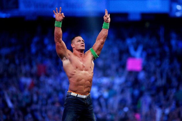 FILE- In this Sunday, April 6, 2014 file photo, John Cena celebrates his win during Wrestlemania XXX at the Mercedes-Benz Super Dome in New Orleans. World-famous WWE wrestlers such as John Cena, Shaemus and champion Randy Orton are in Saudi Arabia for three days of matches in the capital Riyadh. (Jonathan Bachman/AP Images for WWE, File)