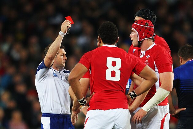 AUCKLAND, NEW ZEALAND - OCTOBER 15:  Wales captain Sam Warburton (hidden) receives a straight red card from Referee Alain Rolland of Ireland (L) for a dangerous tackle on Wing Vincent Clerc of France during semi final one of the 2011 IRB Rugby World Cup between Wales and France at Eden Park on October 15, 2011 in Auckland, New Zealand.  (Photo by David Rogers/Getty Images)