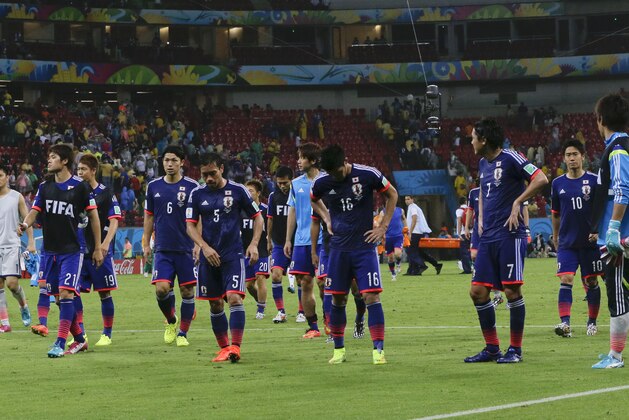 Japanese players leave the pitch after the group C World Cup soccer match between Ivory Coast and Japan at the Arena Pernambuco in Recife, Brazil, Saturday, June 14, 2014.  Ivory Coast won 2-1.  (AP Photo/Shuji Kajiyama)