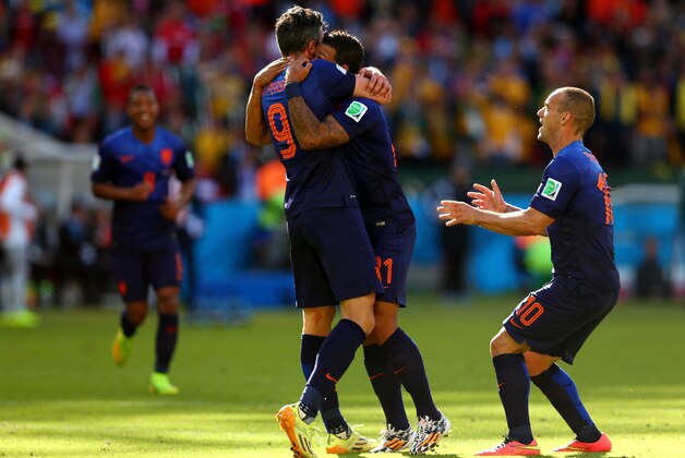 PORTO ALEGRE, BRAZIL - JUNE 18: Memphis Depay of the Netherlands (C) celebrates scoring his team's third goal with Robin van Persie (L) and Wesley Sneijder during the 2014 FIFA World Cup Brazil Group B match between Australia and Netherlands at Estadio Beira-Rio on June 18, 2014 in Porto Alegre, Brazil. (Photo by Quinn Rooney/Getty Images) PORTO ALEGRE, BRAZIL - JUNE 18: Memphis Depay of the Netherlands (C) celebrates scoring his team's third goal with Robin van Persie (L) and Wesley Sneijder during the 2014 FIFA World Cup Brazil Group B match between Australia and Netherlands at Estadio Beira-Rio on June 18, 2014 in Porto Alegre, Brazil. (Photo by Quinn Rooney/Getty Images)
