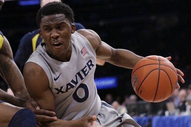 Xavier's Semaj Christon (0) protects the ball from Marquette's Jamil Wilson during the second half of an NCAA college basketball game in the quarterfinals of the Big East men's tournament Thursday, March 13, 2014, at Madison Square Garden in New York. Xavier won 68-65. (AP Photo/Frank Franklin II)