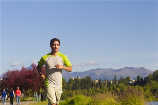 Young Adult Male Running On The Tony Knowles Coastal Trail Near Westchester Lagoon In Summer;Anchorage Alaska Usa. (Design Pics/AP Images)
