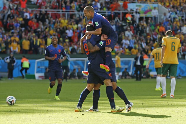 Dutch players celebrate after Netherlands' Memphis Depay scored his side's third goal during the group B World Cup soccer match between Australia and the Netherlands at the Estadio Beira-Rio in Porto Alegre, Brazil, Wednesday, June 18, 2014.  (AP Photo/Wong Maye-E)