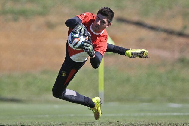 Belgium's goalkeeper Thibaut Courtois jumps to catch the ball during a team training session in Mogi Das Cruzes, Brazil, Friday, June 13, 2014. Belgium play in group H of the 2014 soccer World Cup. (AP Photo/Andrew Medichini)