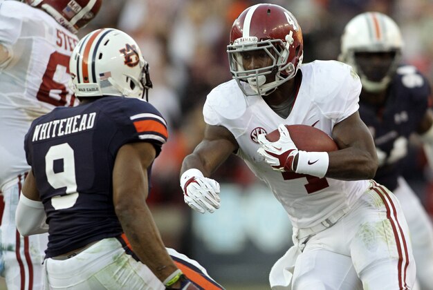 Nov 30, 2013; Auburn, AL, USA; Alabama Crimson Tide running back T.J. Yeldon (4) runs against Auburn Tigers defensive back Jermaine Whitehead (9) during the second quarter at Jordan Hare Stadium. Mandatory Credit: John Reed-USA TODAY Sports