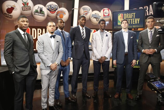 From left, NBA draft prospects Marcus Smart of Oklahoma State, Tyler Ennis of Syracuse, Andrew Wiggins and Joel Embiid of Kansas, Noah Vonleh of Indiana, Doug McDermott of Creighton and Aaron Gordon of Arizona pose for a photograph before the NBA draft lottery in New York, Tuesday, May 20, 2014.  (AP Photo/Kathy Willens)
