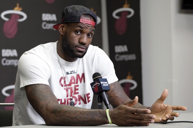 Miami Heat's LeBron James gestures as he answers a question during a news conference in Miami, Tuesday, June 17, 2014. James says he's going on vacation with his family before making any decisions about his future. The Miami Heat held their season-wrap up team meeting on Tuesday afternoon and one of the biggest questions is about the future of the roster. James could become a free agent in a couple of weeks and the four-time MVP says he still has not thought about his plans.(AP Photo/Alan Diaz)