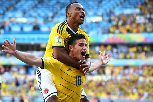 BELO HORIZONTE, BRAZIL - JUNE 14: James Rodriguez of Colombia celebrates scoring his team's third goal with Juan Camilo Zuniga during the 2014 FIFA World Cup Brazil Group C match between Colombia and Greece at Estadio Mineirao on June 14, 2014 in Belo Horizonte, Brazil.  (Photo by Ian Walton/Getty Images)