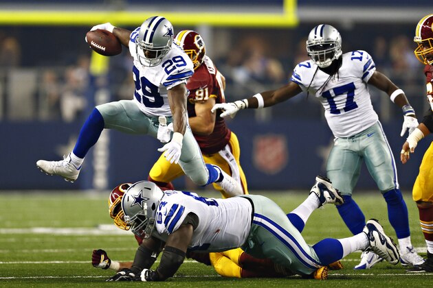 ARLINGTON, TX - OCTOBER 13:  DeMarco Murray #29 of the Dallas Cowboys jumps over a tackle during the first half of a game against the Washington Redskins at  AT&T Stadium on October 13, 2013 in Arlington, Texas.  (Photo by Wesley Hitt/Getty Images)