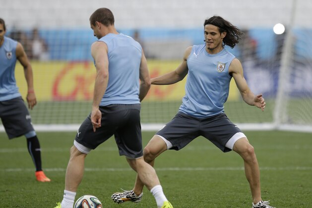 Uruguay national soccer team player Edinson Cavani, right, chases the ball during a squad training session for the 2014 soccer World Cup at Itaquerao Stadium in Sao Paulo, Brazil, Wednesday, June 18, 2014. Uruguay play England in group D of the 2014 soccer World Cup at the stadium on Thursday. (AP Photo/Matt Dunham) Uruguay national soccer team player Edinson Cavani, right, chases the ball during a squad training session for the 2014 soccer World Cup at Itaquerao Stadium in Sao Paulo, Brazil, Wednesday, June 18, 2014. Uruguay play England in group D of the 2014 soccer World Cup at the stadium on Thursday. (AP Photo/Matt Dunham)