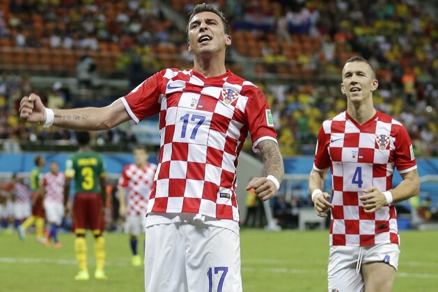 Croatia's Mario Mandzukic, left, celebrates with teammate Ivan Perisic after scoring his side's fourth goal during the group A World Cup soccer match between Cameroon and Croatia at the Arena da Amazonia in Manaus, Brazil, Wednesday, June 18, 2014.  (AP Photo/Marcio Jose Sanchez)