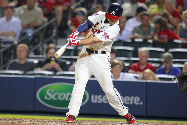 Atlanta Braves Tommy La Stella (7) hits a single in the fifth inning of an interleague baseball game against the Los Angeles Angels Sunday, June 15, 2014, in Atlanta. The Braves won 7-3  (AP Photo/Todd Kirkland)
