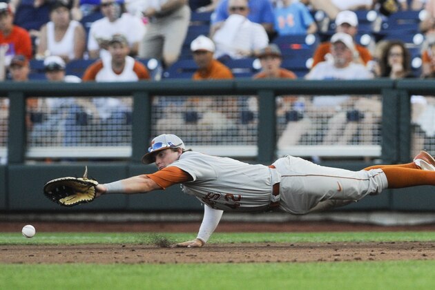Texas first baseman Kacy Clemens (42) attempts to catch the ball hit for a single by UC Irvine's Kris Paulino in the second inning of an NCAA baseball College World Series elimination game in Omaha, Neb., Wednesday, June 18, 2014. (AP Photo/Eric Francis)
