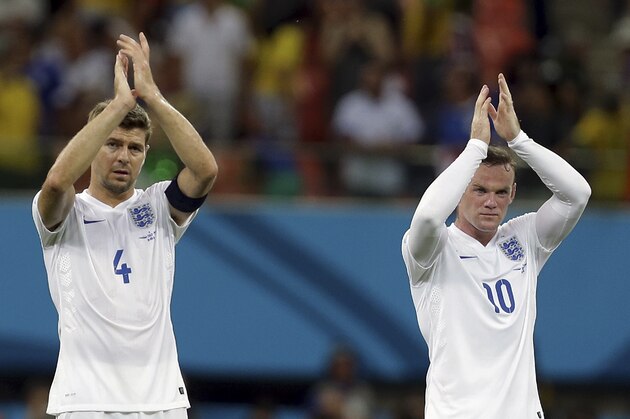 England's Steven Gerrard, left, and Wayne Rooney applaud spectators after the group D World Cup soccer match between England and Italy at the Arena da Amazonia in Manaus, Brazil, Saturday, June 14, 2014. Italy won the match 2-1.  (AP Photo/Martin Mejia)