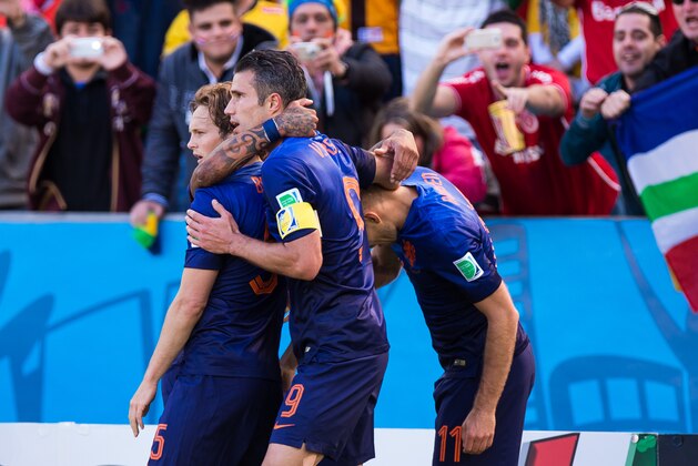 PORTO ALEGRE, BRAZIL - JUNE 18:  Daley Blind, Robin van Persie and Arjen Robben of the Netherlands celebrate after scoring the first goal during the 2014 FIFA World Cup Brazil Group B match between Australia and Netherlands at Estadio Beira-Rio on June 18, 2014 in Porto Alegre, Brazil. (Photo by Vinicius Costa/ Getty Images)