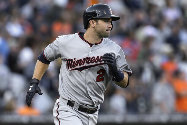 Minnesota Twins' Brian Dozier rounds first base after hitting a two-run home run against the Detroit Tigers in the ninth inning of a baseball game in Detroit, Saturday, June 14, 2014. (AP Photo/Paul Sancya)