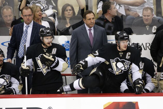 Pittsburgh Penguins' Sidney Crosby (87) climbs over the boards in front of coach Dan Bylsma, left rear, and assistant coach Jacques Martin in the third period of game 7 of a second-round NHL playoff hockey series against the New York Rangers in Pittsburgh Tuesday, May 13, 2014. The Rangers won 2-1, to win the series. (AP Photo)