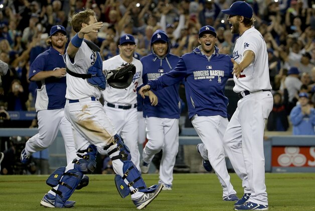 Los Angeles Dodgers starting pitcher Clayton Kershaw celebrates his no hitter with his teammates against the Colorado Rockies after a baseball game in Los Angeles, Wednesday, June 18, 2014. Kershaw struck out a career-high 15 batters. (AP Photo/Chris Carlson)