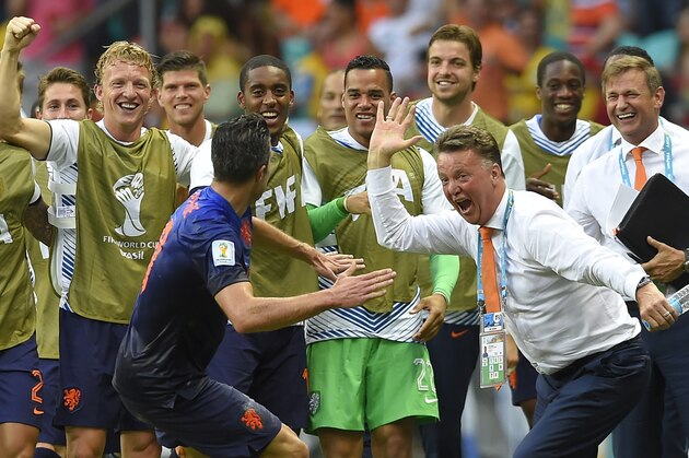 Netherlands' Robin van Persie celebrates with Netherlands' head coach Louis van Gaal after scoring a goal during the group B World Cup soccer match between Spain and the Netherlands at the Arena Ponte Nova in Salvador, Brazil, Friday, June 13, 2014. (AP Photo/Manu Fernandez)