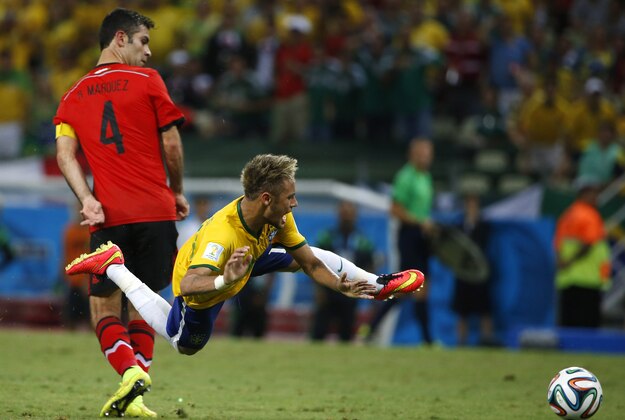 Jun 17, 2014; Fortaleza, Ceara, BRAZIL; Brazil forward Neymar (10) is sent flying by Mexico defender Rafael Marquez (4) during the second half of their 0-0 tie in a 2014 World Cup game at Estadio Castelao. Mandatory Credit: Winslow Townson-USA TODAY Sports