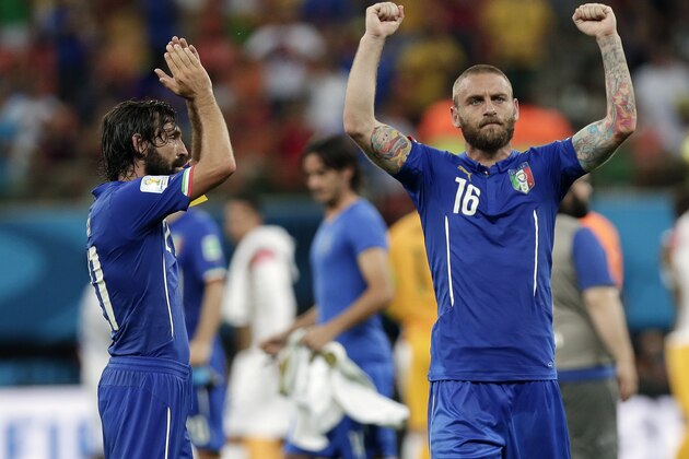 Italy's Andrea Pirlo, left, and Italy's Daniele De Rossi (16) celebrate after their 2-1 victory over England during their group D World Cup soccer match at the Arena da Amazonia in Manaus, Brazil, Saturday, June 14, 2014.