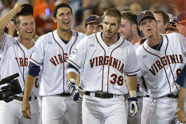 Virginia players celebrate with Mike Papi (38), who hit a double in the ninth inning against Mississippi that scored Thomas Woodruff to win an NCAA baseball College World Series game in Omaha, Neb., Sunday, June 15, 2014. Virginia won 2-1. (AP Photo/Ted Kirk)