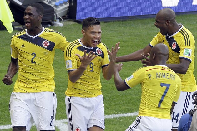 Colombia's Teofilo Gutierrez (9) celebrates with teammates Cristian Zapata, (2) Pablo Armero (7) and Victor Ibarbo, right, after scoring during the group C World Cup soccer match against Greece at the Mineirao Stadium in Belo Horizonte, Brazil, Saturday, June 14, 2014.  (AP Photo/Andrew Medichini)