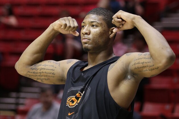 Oklahoma State guard Marcus Smart gestures during practice at the NCAA college basketball tournament Thursday, March 20, 2014, in San Diego. Oklahoma State faces Gonzaga in a second-round game on Friday. (AP Photo/Gregory Bull)