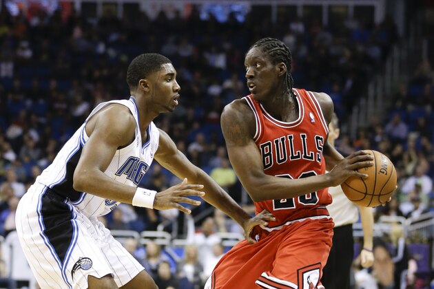Chicago Bulls' Tony Snell, right, looks to pass the ball around Orlando Magic's E'Twaun Moore, left, during the first half of an NBA basketball game in Orlando, Fla., Wednesday, Jan. 15, 2014.(AP Photo/John Raoux)
