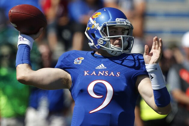 Kansas quarterback Jake Heaps (9) passes to a teammate during the first half of an NCAA college football game against Louisiana Tech in Lawrence, Kan., Saturday, Sept. 21, 2013. Kansas defeated Louisiana Tech 13-10. (AP Photo/Orlin Wagner)