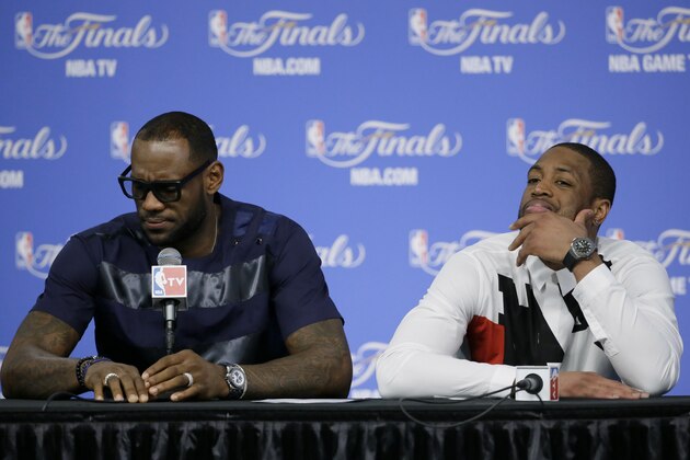 Miami Heat forward LeBron James, left, and Dwyane Wade participate in a news conference after Game 5 of the NBA basketball finals against the San Antonio Spurs, on Sunday, June 15, 2014, in San Antonio. The Spurs won the NBA championship 104-87. (AP Photo/Tony Gutierrez)