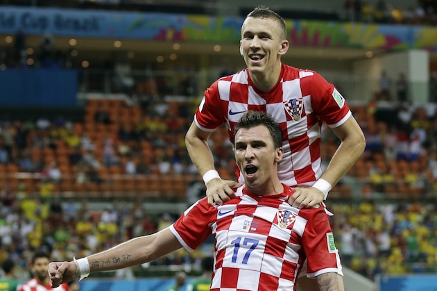 Croatia's Mario Mandzukic (17) celebrates with teammate Ivan Perisic after scoring his side's fourth goal during the group A World Cup soccer match between Cameroon and Croatia at the Arena da Amazonia in Manaus, Brazil, Wednesday, June 18, 2014.   (AP Photo/Martin Mejia)