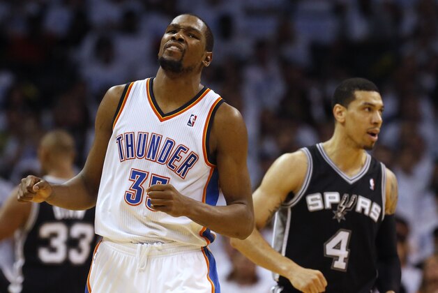 Oklahoma City Thunder forward Kevin Durant (35) and San Antonio Spurs guard Danny Green (4) react in the second half of Game 6 of the Western Conference finals NBA basketball playoff series in Oklahoma City, Saturday, May 31, 2014. (AP Photo/Sue Ogrocki)