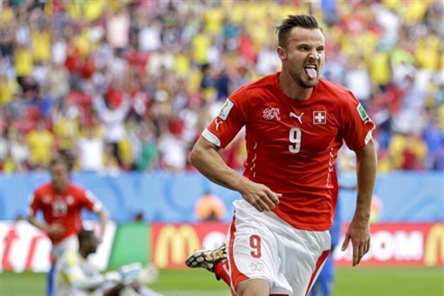Switzerland's Haris Seferovic scores his side's second goal during the group E World Cup soccer match between Switzerland and Ecuador at the Estadio Nacional in Brasilia, Brazil, Sunday, June 15, 2014.  (AP Photo/Michael Sohn)