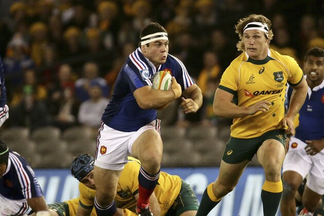 France's Guilhem Guirado, left, runs away from Australia's Michael Cooper, right, during their Rugby test match in Melbourne, Australia, Saturday, June 14, 2014. (AP Photo/Hamish Blair)
