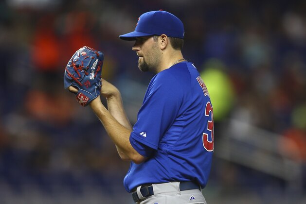 Chicago Cubs starter Jason Hammel studies a Miami Marlins batter after giving a two-run home run during the first inning of a baseball game in Miami, Monday, June 16, 2014. (AP Photo/J Pat Carter)