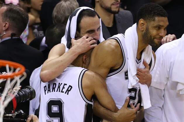 SAN ANTONIO, TX - JUNE 15:  Tony Parker #9, Manu Ginobili #20 and Tim Duncan #21 of the San Antonio Spurs hug as their team defeats the Miami Heat in Game Five of the 2014 NBA Finals at the AT&T Center on June 15, 2014 in San Antonio, Texas. NOTE TO USER: User expressly acknowledges and agrees that, by downloading and/or using this photograph, user is consenting to the terms and conditions of the Getty Images License Agreement. (Photo by Chris Covatta/Getty Images)