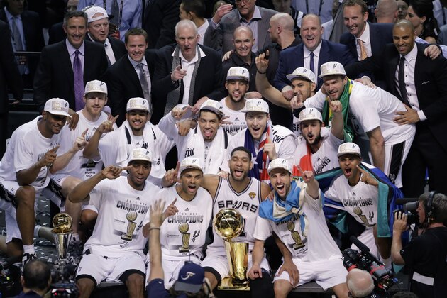 The San Antonio Spurs pose for a photo after Game 5 of the NBA basketball finals against the Miami Heat on Sunday, June 15, 2014, in San Antonio. The Spurs won the NBA championship 104-87. (AP Photo/Tony Gutierrez)