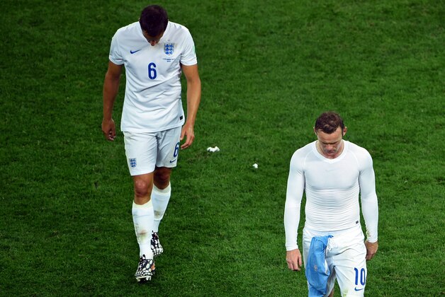 SAO PAULO, BRAZIL - JUNE 19:  A dejected Phil Jagielka (L) and Wayne Rooney of England walk off after being defeated by Uruguay 2-1 during the 2014 FIFA World Cup Brazil Group D match between Uruguay and England at Arena de Sao Paulo on June 19, 2014 in Sao Paulo, Brazil.  (Photo by Matthias Hangst/Getty Images)