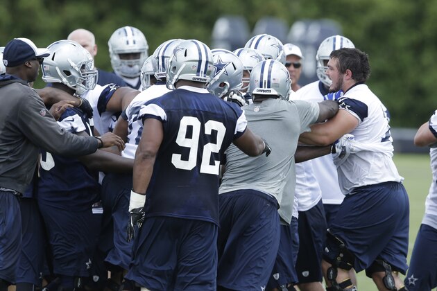 Dallas Cowboys mix it up as rookie guard Zach Martin, right, is held back during an NFL football minicamp Wednesday, June 18, 2014, in Irving, Texas. (AP Photo/LM Otero)