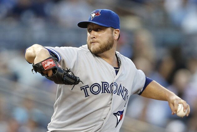 Toronto Blue Jays starting pitcher Mark Buehrle (56) winds up in the third inning of  a baseball game \ay]\ at Yankee Stadium in New York, Wednesday, June 18, 2014.  (AP Photo/Kathy Willens)